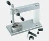 A metal workbench tool with black handles and several small metal pieces on a light gray background. Produktbild-Vorschau