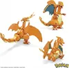 A collage of three different poses of a toy dragon, likely a Charizard from Pokémon, built from interlocking bricks. Voir les images du produit