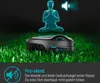 A robotic lawnmower is shown on a grassy lawn with a glowing silhouette of a person meditating above it, symbolizing quiet operation. Produktbild-Vorschau