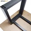 A black metal table leg assembly is attached to a wooden tabletop with screws. Produktbild-Vorschau