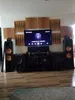 A home entertainment system setup with speakers, a TV, and sound-absorbing panels on the wall. Podgląd zdjęcia produktu