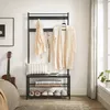 A hallway stand with clothes hanging on it, a bench with shoes and folded items, and a guitar next to it. Produktbild-Vorschau