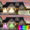 A house with garage doors illuminated by different colored lights. Produktbild-Vorschau