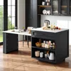 A modern kitchen with a black island and a white countertop, featuring various kitchen items and a large window. Anteprima dell’immagine prodotto