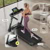 A woman is running on a treadmill in a modern living room setting. There are also graphical callouts with product specifications. Produktbild-Vorschau