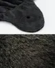 A close-up view of a dark grey, plush material, likely a pet bed or cushion, with a small circular opening visible. Produktbild-Vorschau