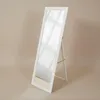 A full-length white mirror with a stand is shown against a plain light beige background. Náhľad obrázku produktu