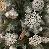 A close-up view of a decorated Christmas tree with various ornaments. Náhled obrázku produktu