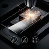 A close-up of a drill creating sparks on a piece of glass, with icons below representing security, durability, and connectivity. Voir les images du produit