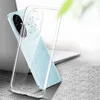 A clear phone case is shown on a light blue phone, placed on a textured surface with a laptop in the background. Anteprima dell’immagine prodotto
