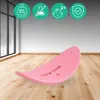 A pink balance board is shown on a wooden floor in a room with large windows. Podgląd zdjęcia produktu