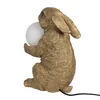 A gold-colored rabbit figurine holding a white orb, likely a lamp. Náhled obrázku produktu