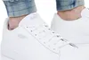 Close-up of a person wearing white Puma sneakers. Produktbild-Vorschau