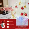 A close-up of a white artificial Christmas tree decorated with red and gold ornaments, with marketing text overlays. Produktbild-Vorschau
