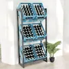 A metal shelving unit filled with blue crates containing bottles, standing against a wall with a plant to the side. Náhľad obrázku produktu