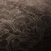 A close-up view of a textured fabric with an embossed floral pattern. Produktbild-Vorschau
