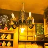 A miniature diorama of a magical school room, featuring a chandelier, shelves with potion bottles, and a chalkboard with diagrams. Voir les images du produit