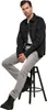 A man is sitting on a stool, wearing a black jacket and grey pants. Náhled obrázku produktu
