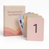 A box of sensory learning cards with several cards fanned out in front of it. Produktbild-Vorschau