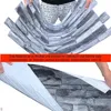 A person is holding up flexible wall panels designed to look like stone. Produktbild-Vorschau