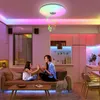 A mother and daughter are playing patty-cake on a couch in a modern living room with colorful LED lighting. Voir les images du produit