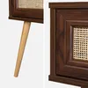 Close-up details of a wooden furniture item with cane detailing. Produktbild-Vorschau