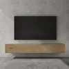 A modern wall-mounted TV stand with a black TV above it, set against a concrete wall. Anteprima dell’immagine prodotto