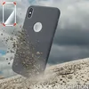 A dark gray phone case is shown falling and kicking up dirt, with a cloudy sky in the background. A small graphic in the top left shows a transparent phone case with red corner highlights. Produktbild-Vorschau