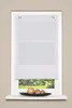 A white roman blind is shown hanging in a window, with a decorative bowl of spheres on the windowsill below. Produktbild-Vorschau