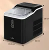 A black ice maker with a transparent lid, shown on a light beige background with dimensions indicated. Náhled obrázku produktu
