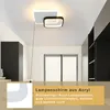 A modern ceiling light fixture in a room with black cabinets and a window. Produktbild-Vorschau