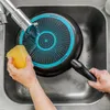 A person is washing a frying pan in a sink. Náhled obrázku produktu