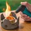 A hand holding a teal and black torch igniting a small camping stove with a flame. Produktbild-Vorschau