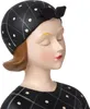 Close-up of a decorative figurine of a woman wearing a polka dot headscarf and dress. Anteprima dell’immagine prodotto