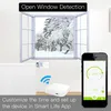 A smart thermostat for a radiator is shown in a room with an open window showing a snowy scene. A smartphone displays the app interface for controlling the thermostat. Podgląd zdjęcia produktu