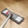 A mop with a microfiber chenille cover is being used to clean a wooden floor. Produktbild-Vorschau