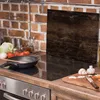 A kitchen counter with a stovetop, cooking utensils, and ingredients. Produktbild-Vorschau