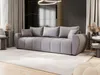 A modern living room with a large gray sofa, decorative pillows, and a rug. Voir les images du produit