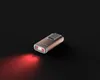A single gold flashlight is shown on a black background, emitting a red light. Produktbild-Vorschau