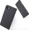 Two black flip phone cases are shown against a white background. One case is open, showing the inside of the cover and the camera cutout of the phone it protects. The other case is closed and lying on its side. Náhled obrázku produktu