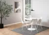 A dining table set in a modern dining room. Voir les images du produit