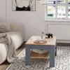 A living room scene with a couch, coffee table, and rug. Produktbild-Vorschau