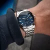 A close-up shot of a man's wrist wearing a silver Casio Edifice watch with a blue textured dial. Produktbild-Vorschau