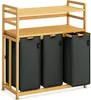 A wooden laundry sorter with three black fabric bins and two shelves. Anteprima dell’immagine prodotto