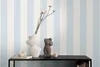 A shelf with decorative items against a striped wallpaper. Produktbild-Vorschau