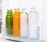 Four glass bottles of drinks in a refrigerator shelf. Produktbild-Vorschau