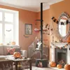 A living room decorated for Halloween, featuring a cat tree and various Halloween decorations. Produktbild-Vorschau