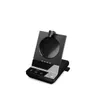 A black headset charging base with a USB dongle attached, shown against a white background. Podgląd zdjęcia produktu
