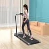 A woman is using a treadmill in a living room. Náhled obrázku produktu