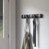 A wall-mounted coat rack with two items hanging on it. Anteprima dell’immagine prodotto